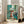 Contemporary abstract wall art showing a contemplative room scene with turquoise window frame, ochre accents, and stark black line work.