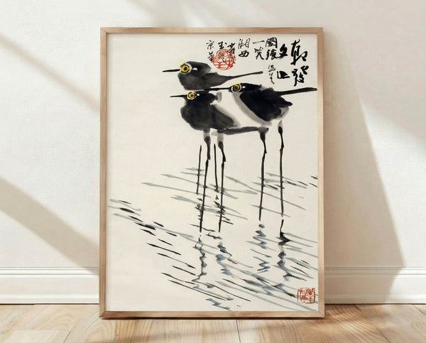 Serene sumi-e ink wash painting of wading birds in shallow water with grass, rendered in black and gray tones on cream background, framed as a minimalist Japanese art print.