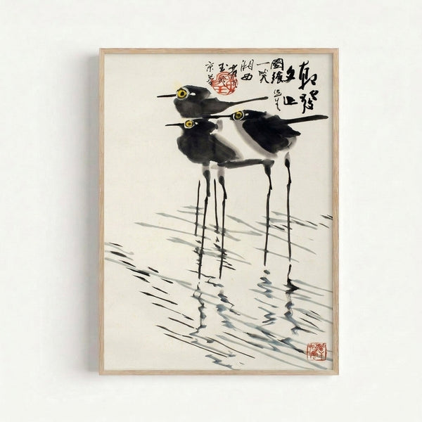Contemplative Japanese woodblock-style artwork depicting long-legged birds wading among grass and water, executed in black ink and yellow ochre with delicate minimalist grace.