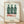 Pop art poster featuring three Coca-Cola bottles rendered in bold green, black, and white with a mechanistic, iconic style characteristic of Warhol's work.