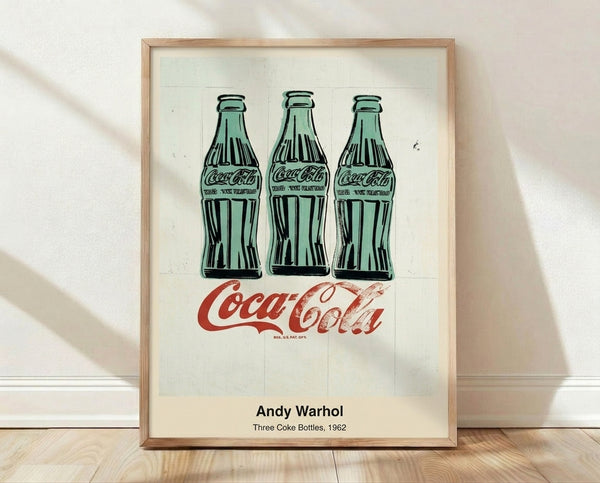 Pop art poster featuring three Coca-Cola bottles rendered in bold green, black, and white with a mechanistic, iconic style characteristic of Warhol's work.