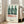 Wall art poster showcasing three soda bottles in green and black, rendered with the mechanistic precision and iconic simplicity of pop art.