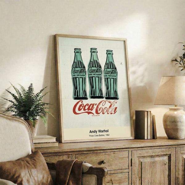 Pop art framed print of three Coke bottles in green, black, and white, capturing the movement's fascination with mass production and everyday objects.