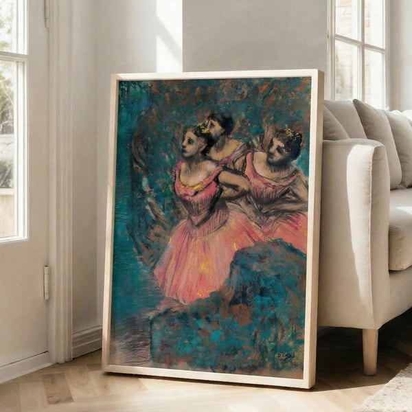 Framed classical ballet artwork featuring three dancers in vivid red attire, rendered with soft impressionistic brushwork emphasizing movement and elegance against a muted backdrop.