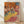 Impressionist ballet scene featuring three dancers in flowing yellow skirts, rendered in soft pastels with muted earth tones and delicate brushwork, framed poster on wall.