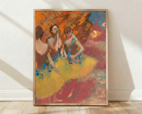 Impressionist ballet scene featuring three dancers in flowing yellow skirts, rendered in soft pastels with muted earth tones and delicate brushwork, framed poster on wall.
