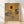 Abstract portrait poster featuring three distorted figures and a fragmented face in muted earth tones and grays, creating an unsettling, existential mood on a framed gallery wall.
