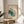 Three barn owls depicted in flowing line art with a muted cream and warm brown palette accented by teal, creating a serene and minimalist wall display.