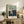 Abstract triptych wall art depicting three studies of a man's back set within geometric cage structures, rendered in muted cream, black, and ochre tones with psychologically charged intensity.