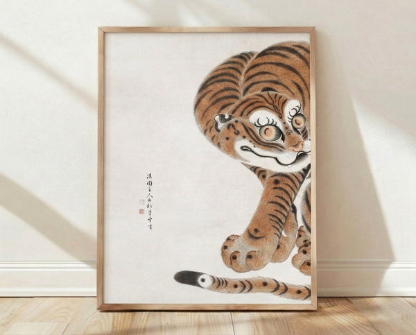 Framed Japanese woodblock-style tiger print with intricate black line work and warm burnt orange accents on cream background, displaying contemplative whimsy in Japandi aesthetic.