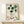 Midcentury minimalist wall art print with Japanese design influence, displaying a ceramic cup and utensil in subdued earth tones of forest green, cream, and black.