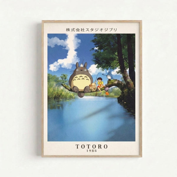 Peaceful Studio Ghibli-inspired art print of Totoro and a young figure by a woodland stream, rendered in delicate watercolor with pale yellows and greens, framed and displayed on a wall.