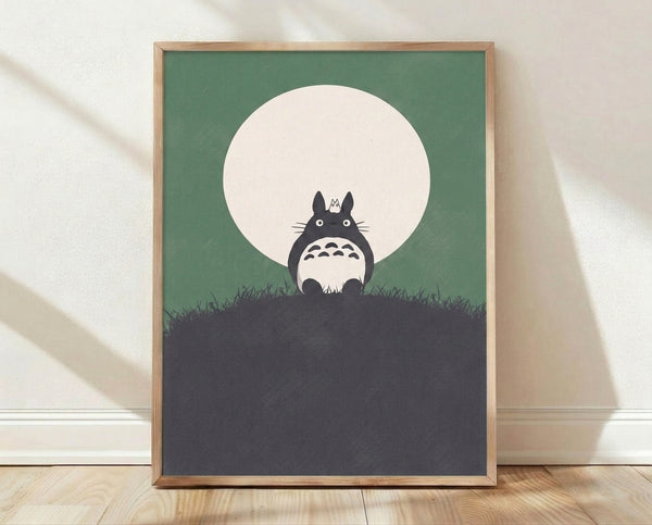 Minimalist framed poster featuring a silhouetted Totoro sitting on a grassy hill beneath a glowing moon, rendered in sage green, dark gray, and cream tones with a peaceful, whimsical mood.