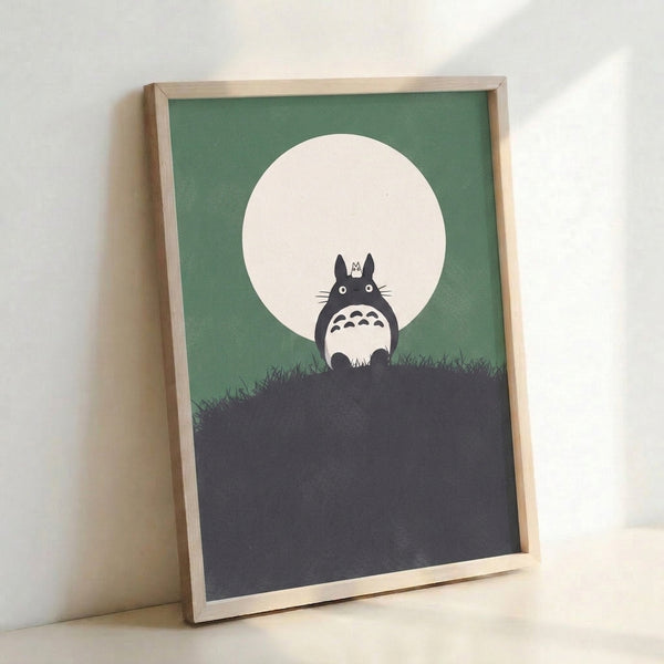 Framed wall art depicting a solitary Totoro figure gazing at the moon from a hilltop, modern minimalist style with muted sage, cream, and gray colors.