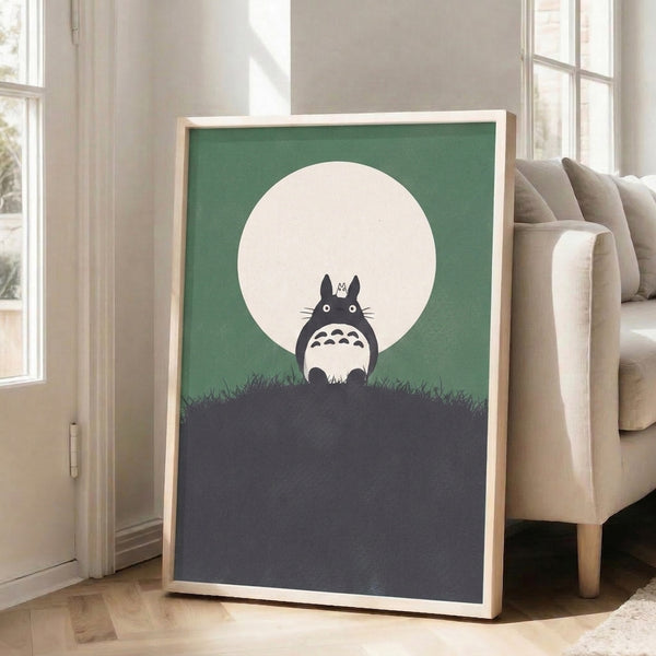 Japanese anime-inspired framed print of Totoro under moonlight on a grassy slope, combining whimsical subject matter with minimalist aesthetic in cool sage and gray tones.