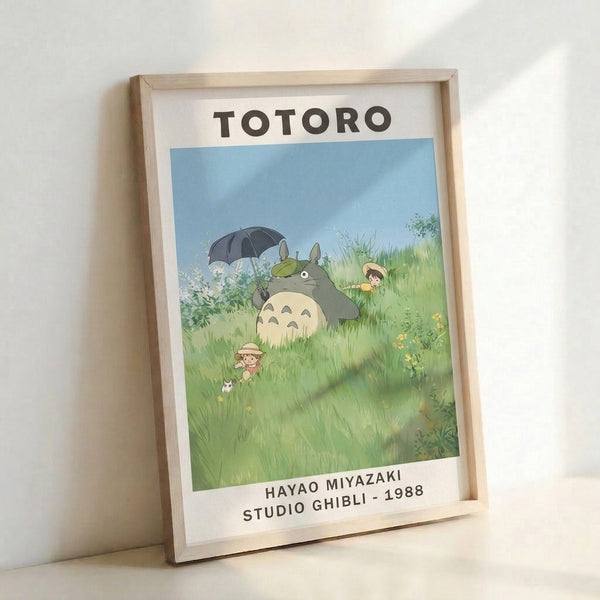 Serene anime poster art showing Totoro amid blooming grassland with an umbrella, rendered in dreamy watercolor-inspired tones of soft green and light blue.