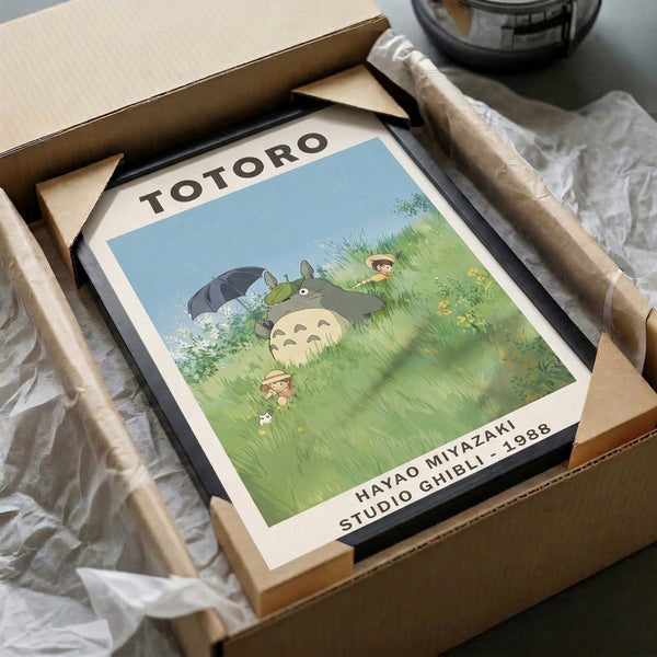 Serene artistic print of Totoro sheltering beneath an umbrella in a peaceful flower-dotted grassland, styled in the distinctive Ghibli aesthetic with soft warm and cool tones.