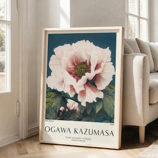 Framed art print showcasing an exquisite peony bloom with layered petals in cream and rose hues, deep red stamen details, and graceful sage-green stems and foliage.