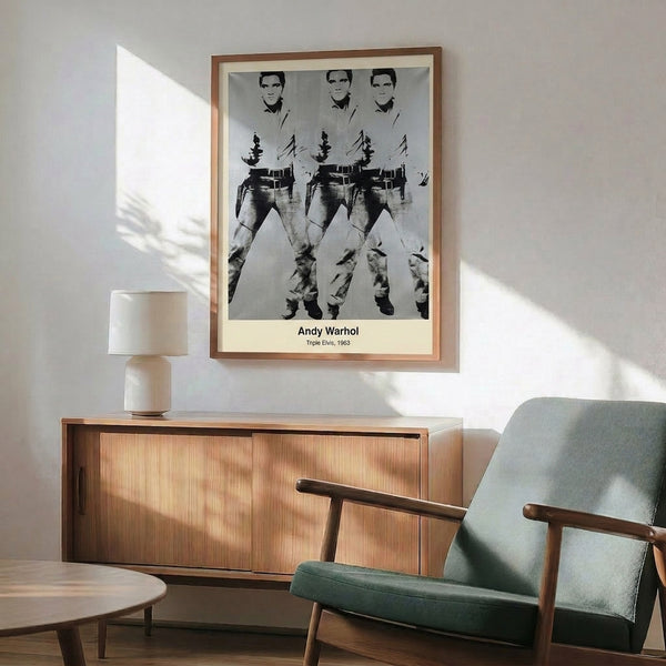 Framed pop art print featuring the legendary musician Elvis in tripled form, rendered in bold gold, magenta, and cyan colors against a black ground.