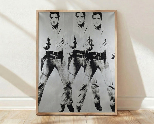 Pop art style poster featuring three repeated images of Elvis Presley in a cowboy outfit, rendered in vibrant colors with bold graphic treatment characteristic of Warhol's iconic style.