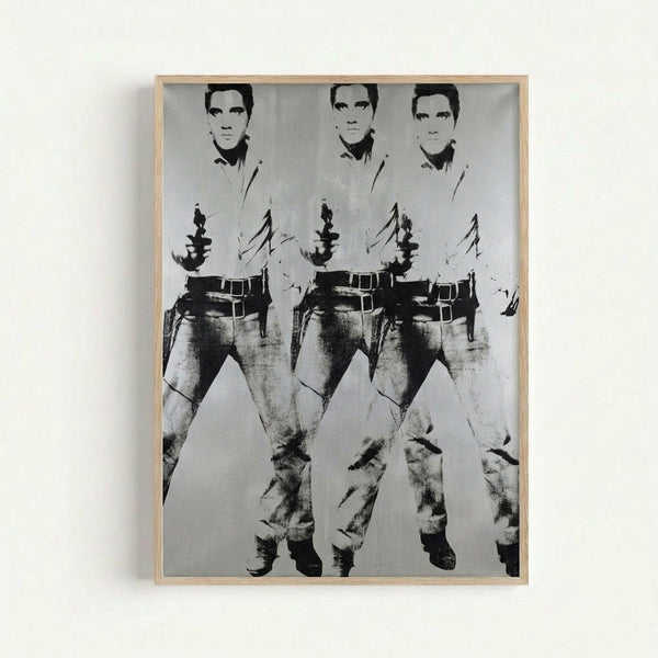 Framed art print displaying Andy Warhol's Triple Elvis composition, showing the legendary musician replicated three times in classic pop art fashion with contrasting color variations.