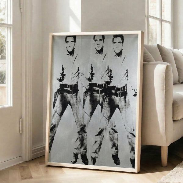 Vibrant pop art print showing Elvis Presley repeated three times in a western costume, executed in Warhol's distinctive high-contrast color and silkscreen-inspired aesthetic.