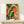 Framed boho wall art displaying tropical fruits and flowering vines in burnt orange, golden yellow, and deep green tones with organic Art Nouveau design.