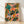 Vibrant modern boho poster featuring two jazz musicians at a grand piano surrounded by lush tropical plants and an enthusiastic audience, rendered in coral, teal, golden yellow, and forest green tones.