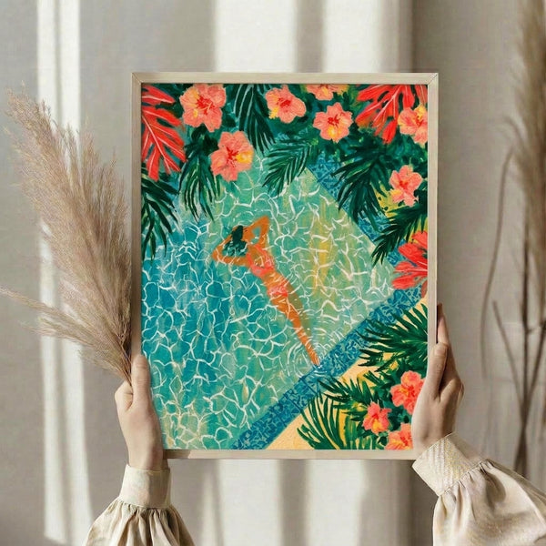 Framed boho watercolor print featuring a dreamy woman immersed in turquoise poolside waters with cream and coral botanical elements in a coastal aesthetic.