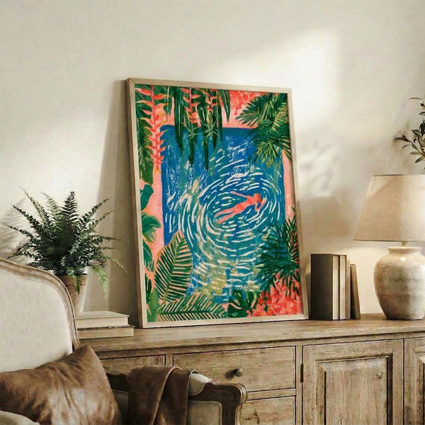 Modern art print featuring a contemplative figure in deep blue ocean waters with golden yellow and cream accents of tropical foliage, evoking a summery escape.
