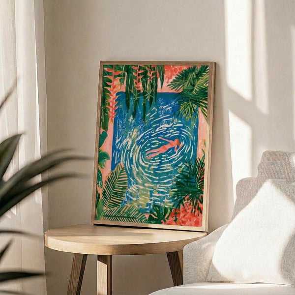 Serene coastal artwork in gouache showing a solitary swimmer amid vibrant coral pink blooms and lush green palms against calm turquoise waters, framed on a wall.