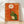 Framed retro folk art poster of a tortoise gently holding a golden daisy flower, rendered in warm burnt orange, cream, and forest green tones with a whimsical, hopeful mood.