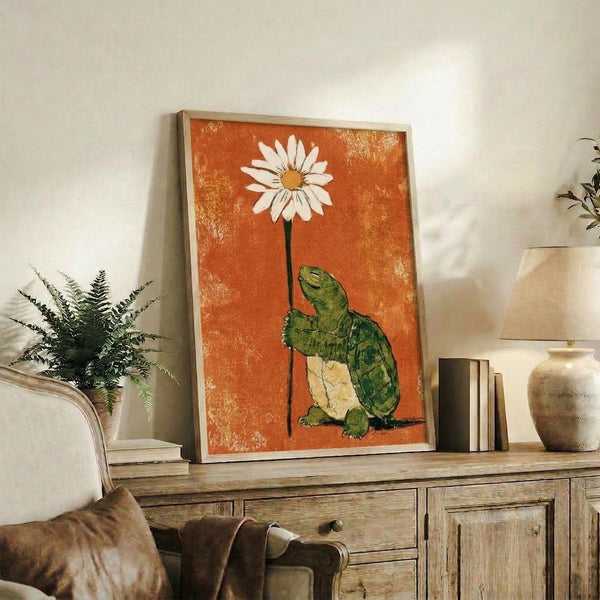 Warm and whimsical framed poster art depicting a tortoise with a daisy flower, blending retro and folk art aesthetics in a palette of burnt orange, cream, and forest green.