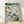 Serene Japanese woodblock art print depicting turtles swimming among aquatic plants in a pond, rendered in forest green, sage blue, and cream tones with meditative naturalistic detail.