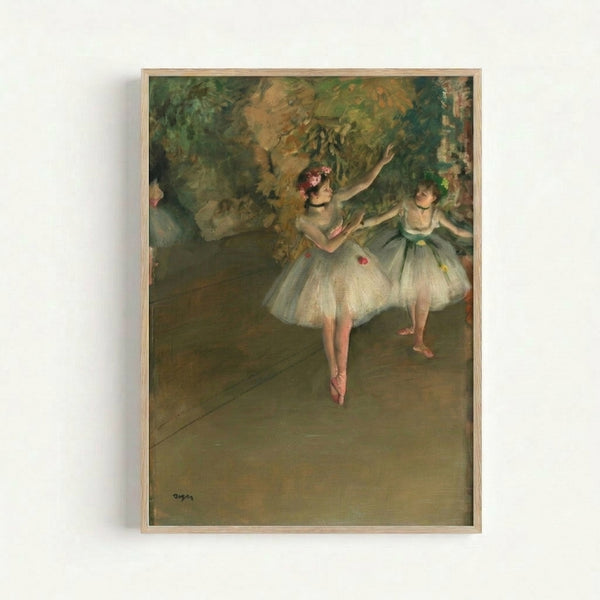 Framed art print showing two faceless ballet dancers in flowing tutus, rendered in delicate impressionist style with warm beige and soft pink hues.