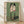 Japanese woodblock print featuring two mirrored faces of a woman with contemplative expression, surrounded by symbolic elements including coins and rope, rendered in sage green, cream, black, and red tones.