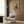 Modern surrealist poster of two figures with a dragonfly in soft, layered tones creating an ethereal and imaginative composition on a gallery wall.