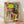 Surreal abstract poster featuring two stylized figures and a dragonfly in black, red, blue, and yellow on white background, evoking a dreamlike and whimsical mood.
