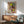 Surrealist wall art showcasing abstract figures and a dragonfly in black, red, blue, and yellow pigments, evoking an introspective and imaginative atmosphere.