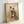 Framed art print of two poised geisha in flowing kimonos near a decorative lantern surrounded by grass, created in the serene Japanese woodblock tradition with cream, black, red, and green hues.