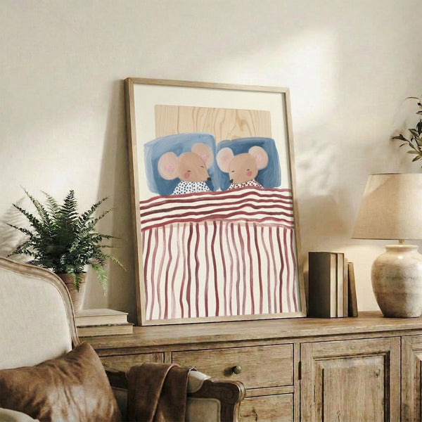 Framed watercolor art print featuring sleeping mice nestled in bed with cream and pale pink bedding, evoking a cozy, peaceful nursery aesthetic with cottagecore charm.