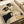 Traditional Japanese art print with two geishas, a kettle, and calligraphic ink brushwork in cream, black, and gold palette creating serene, refined wall décor.