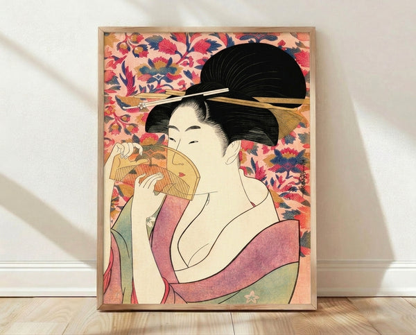 Serene geisha in flowing kimono holding a decorative fan, rendered in traditional Japanese woodblock style with soft blush pink, gold, and navy blue tones.