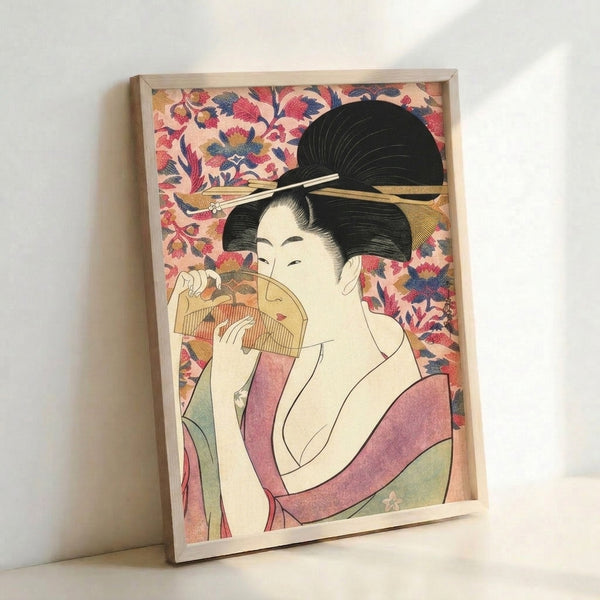 Traditional Japanese woodblock print featuring a composed geisha figure with ornate fan and floral elements, combining soft pink and navy hues for a tranquil, refined mood.