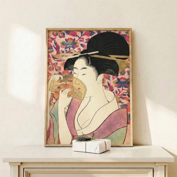 Framed geisha portrait in authentic Japanese woodblock style, showcasing delicate gold detailing and a serene expression against cream and blush tones.