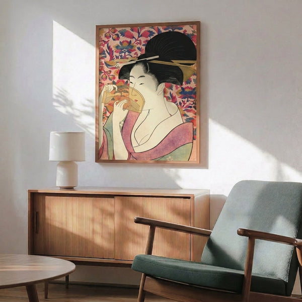 Serene geisha portrait displayed as framed wall art, featuring traditional woodblock printmaking with soft pink, navy blue, and gold accents creating an elegant, cultural aesthetic.