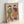Two geishas in elaborate kimonos with intricate patterns in muted olive, rose, and warm cream tones, captured in serene traditional Japanese woodblock print style on framed poster.