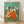 Impressionist painting of ballet dancers in flowing red and yellow skirts, captured in graceful poses with soft ochre and pale blue tones, framed as wall art.