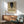 Poster art of a distorted standing man rendered in somber creams, grays, and blacks with rust highlights, expressing existential isolation through abstraction.