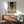 Dark expressionist poster art depicting a lone figure in muted browns and grays, with fragmented form and brooding atmosphere suggesting isolation and introspection.